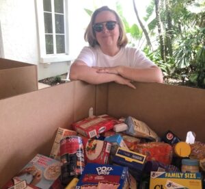 Woman with a box of donated dry foods.
